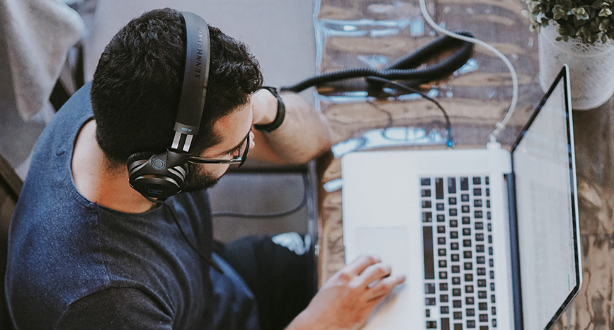 Man wearing headphones at computer