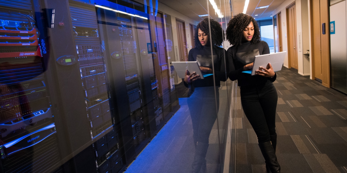 woman in server room on computer